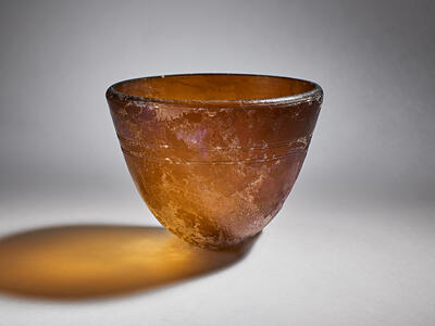 Glass bowl with an uneven surface.
