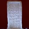 Upright stone slab engraved with a simple relief of a horn.