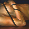 Painting of nude torso on back with leather strap over arm and chest.