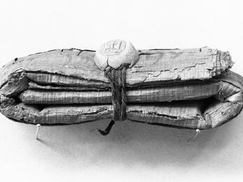 Papyrus, Rolled, Folded, and Sealed Bundle of folded papyrus tied with string and seal.