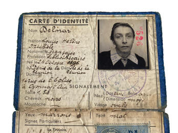Folded identity document with woman's photo and French writing