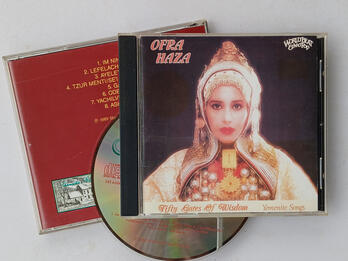 Front and back of CD case with CD. The front has a picture of a woman in Yemenite dress, with the words "Ofra Haza" on the top left, and "Fifty Gates of Wisdom" and "Yemenite Songs" on the bottom.