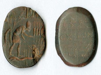 Two views of an ancient engraved oval stone: one side shows a standing, bent-over figure with an arm extended, while the other side displays several lines of inscribed text.