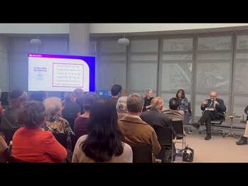 photo of panel of speakers in front of an audience