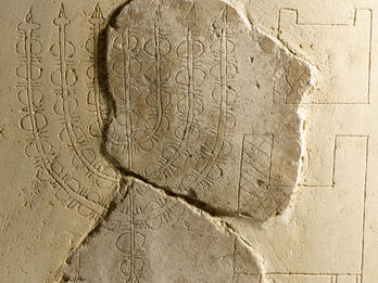 Plaster relief with image of seven-branched candelabrum. 