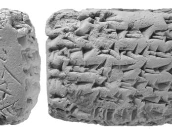 Clay tablet with cuneiform inscription.