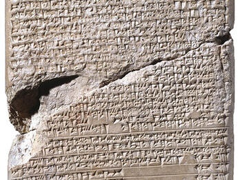 Idol-quickening Instructions Stone tablet with large crack in middle inscribed with Akkadian writing.