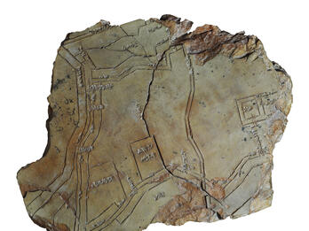 City Plan Incised on Clay Tablet Tablet with etching of lines and squares, cracked in half.