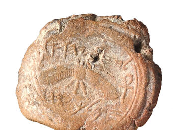Stone seal with image of winged figure and Hebrew inscription. 