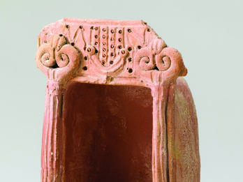 Model Shrine from Tirzah Limestone triple-recessed door frame with row of protruding roof beams.
