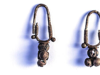 Pair of earrings with rounded attachment.