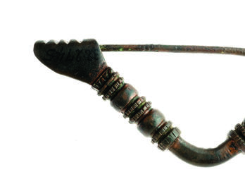 Fibula Triangular bronze pin decorated with ornamental bands, with clasp in the shape of a hand.