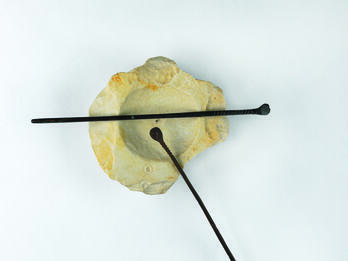 Cosmetic Implements Limestone bowl and two small bronze spatulas resting on it.