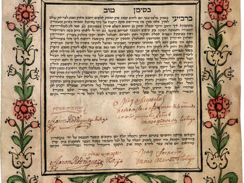 Ketubah Page of Aramaic text framed by floral ornament with crown in top center and signatures in Roman alphabet and Spanish writing on bottom.