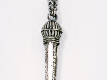 Torah Pointer Object with hook and Hebrew imprinted along decorative handle.