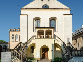 Photograph of exterior of stone building with double staircase.