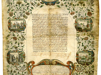 Ketubah Page of Aramaic text with illustration of pair of hands clasped at top and illustrated vignettes along sides of text depicting wedding scenes, joined by vines and flowers.