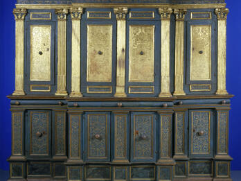 Urbino Synagogue, Italy Photograph of ornamental Torah ark chamber with gilded columns and doors with filigree and Hebrew writing.