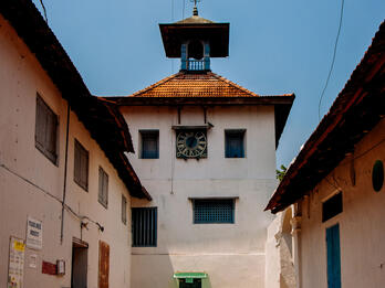 Paradesi Synagogue, Cochin, India Exterior photograph of intersecting walls of stone buildings with tile roofs.