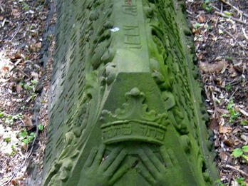 Tombstone of Abraham Cohen Pimentel Tombstone in the shape of a triangular prism with carving of open book on short end with Hebrew and Portuguese inscriptions and decoration along length of stone.
