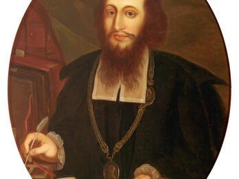Portrait of Samson Wertheimer Portrait painting of bearded man wearing medallion holding quill and papers and facing viewer.