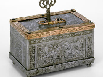 Jewelry Box Metal box engraved with images of dogs and foliage, with handle and key on top.