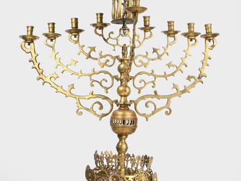 Synagogue Hanukkah Lamp (Poland) Nine-branched candelabrum with small carved eagle on top and crown shape on base.