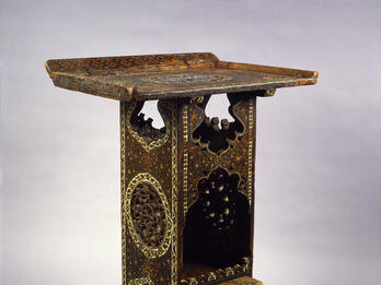 Wooden lectern with geometric designs.