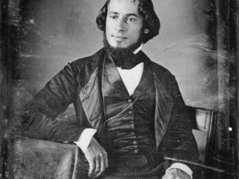 Self-Portrait Portrait of man in suit facing slightly angled, seated with his arm resting on the table.