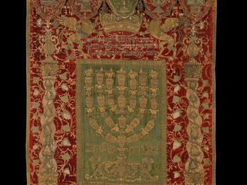 Embroidered curtain and valence bearing three crowns and five vessels.