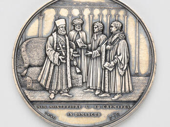 Medal Commemorating Sir Moses Montefiore Silver medal depicting four men talking.