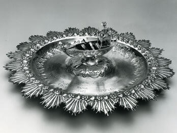 Alms Plate Silver plate featuring a boat in the center.