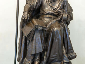 Ivan the Terrible A sculpture of man with book and beads seated on throne.