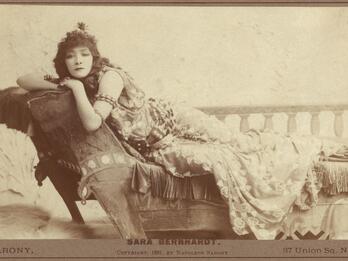 Sarah Bernhardt as Cleopatra Photograph of woman lying on chaise lounge facing viewer.