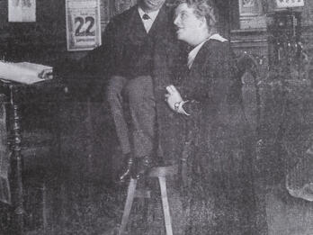 Photograph of two figures looking at each other.
