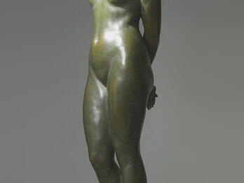 The Captive Sculpture of nude woman looking down.