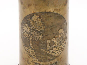 Cylinder with etching of stone building along street, with Hebrew and English text in ribbons on bottom.