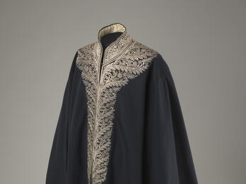 Coat with an ornately embroidered neckline.