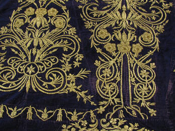 An Ottoman Torah Ark Curtain Made from a Woman's Dress Cloth embroidered with decorative flowers, spirals, and lines.