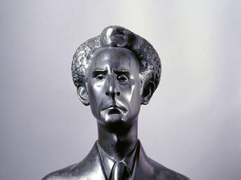 Bust of man in suit and tie.