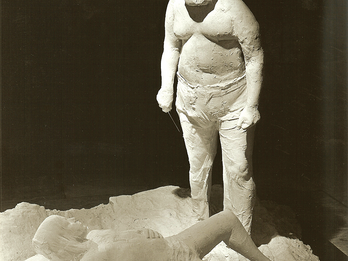Sacrifice of Isaac Sculpture of a man standing over a boy lying on his back.