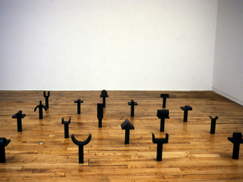 Commandment II Forged iron installation of glyphs resting on squat pedestals.