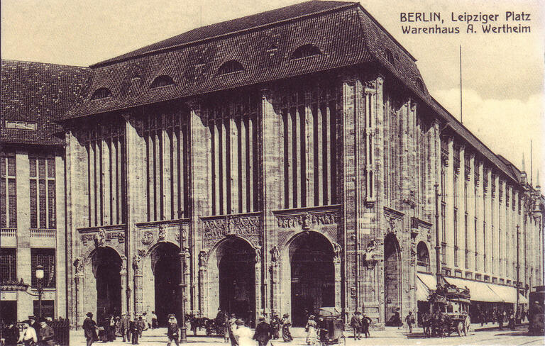 Postcard depicting exterior of building with many columns built into its walls.