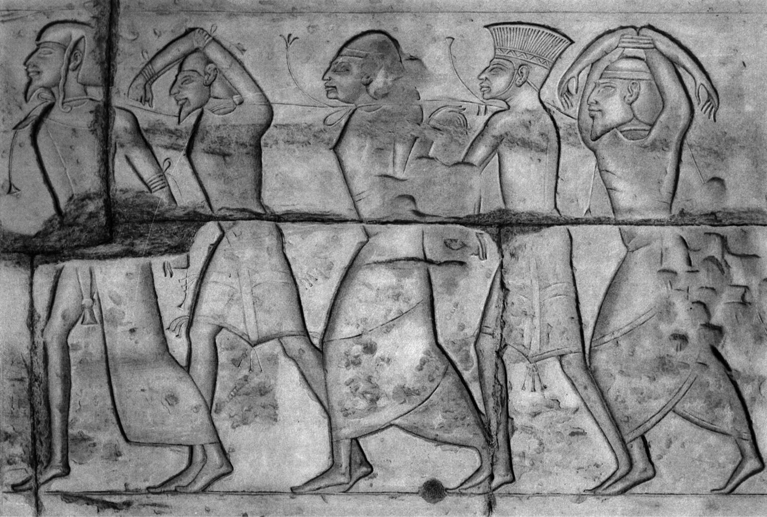 Relief of five figures in profile wearing different head coverings. Relief of five figures in profile wearing different head coverings.