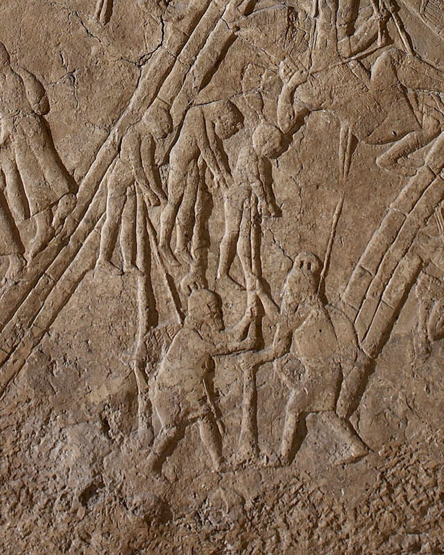 Relief of two people impaling three people.