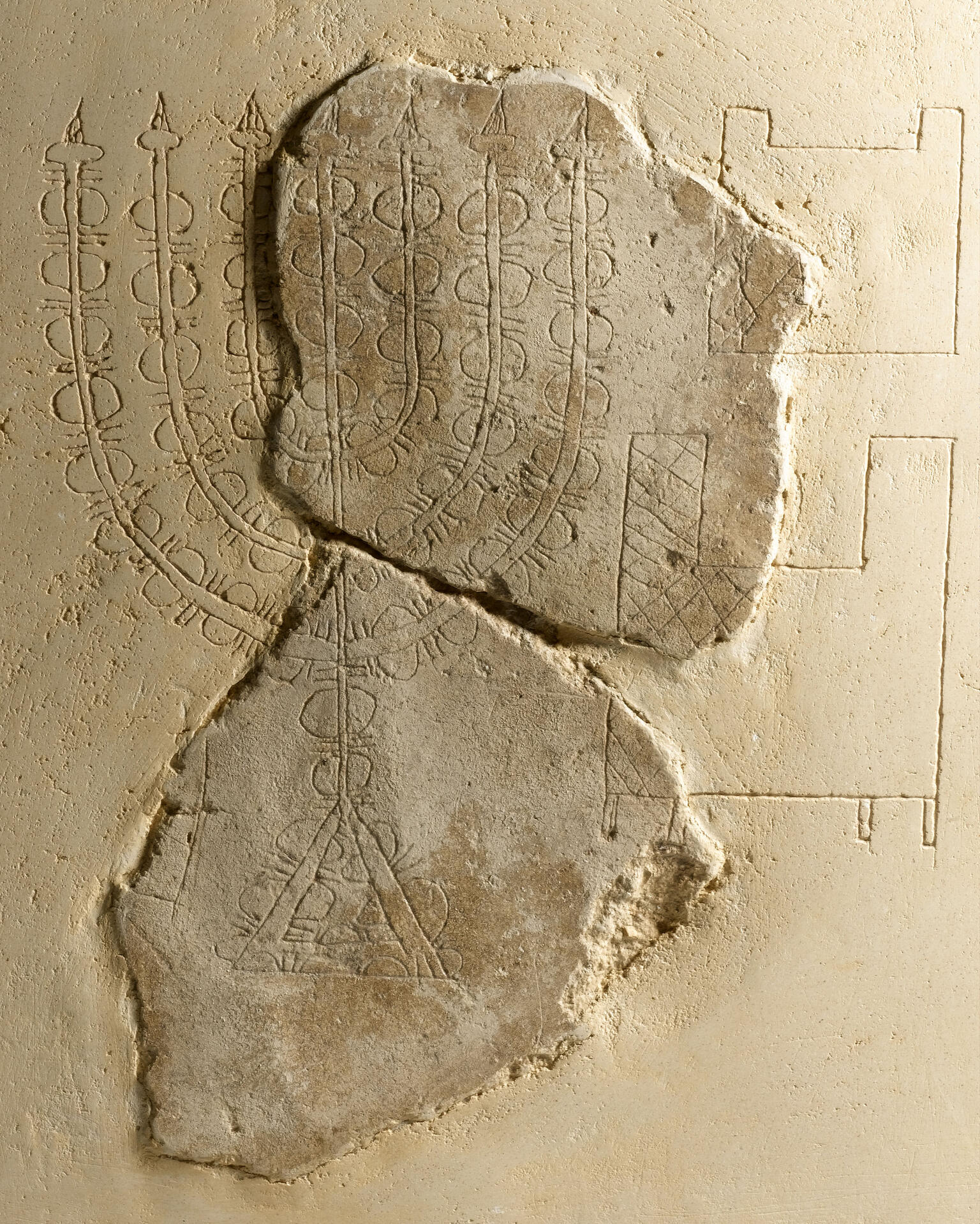 Plaster relief with image of seven-branched candelabrum.