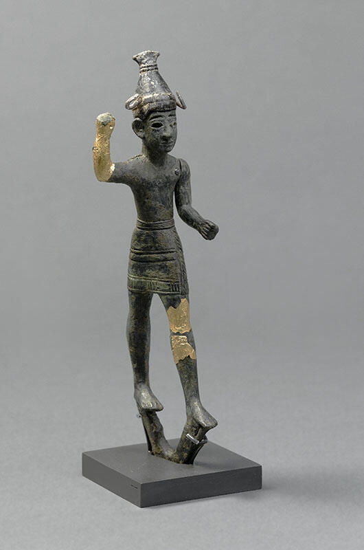 Figurine with horned helmet and raised hand, with gilded bronze on hand and thigh. Figurine with horned helmet and raised hand, with gilded bronze on hand and thigh.