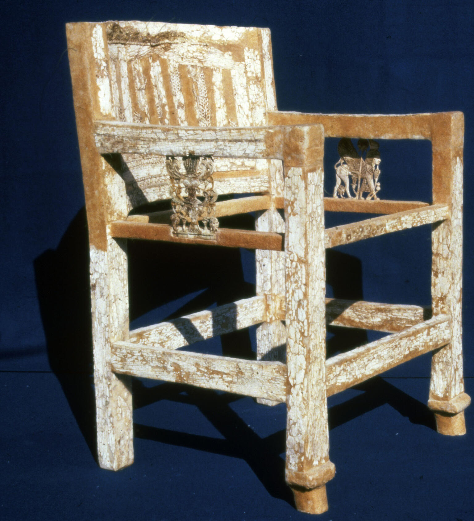 Armed chair decorated with ivory inlay including elaborate carving on arms. Armed chair decorated with ivory inlay including elaborate carving on arms.