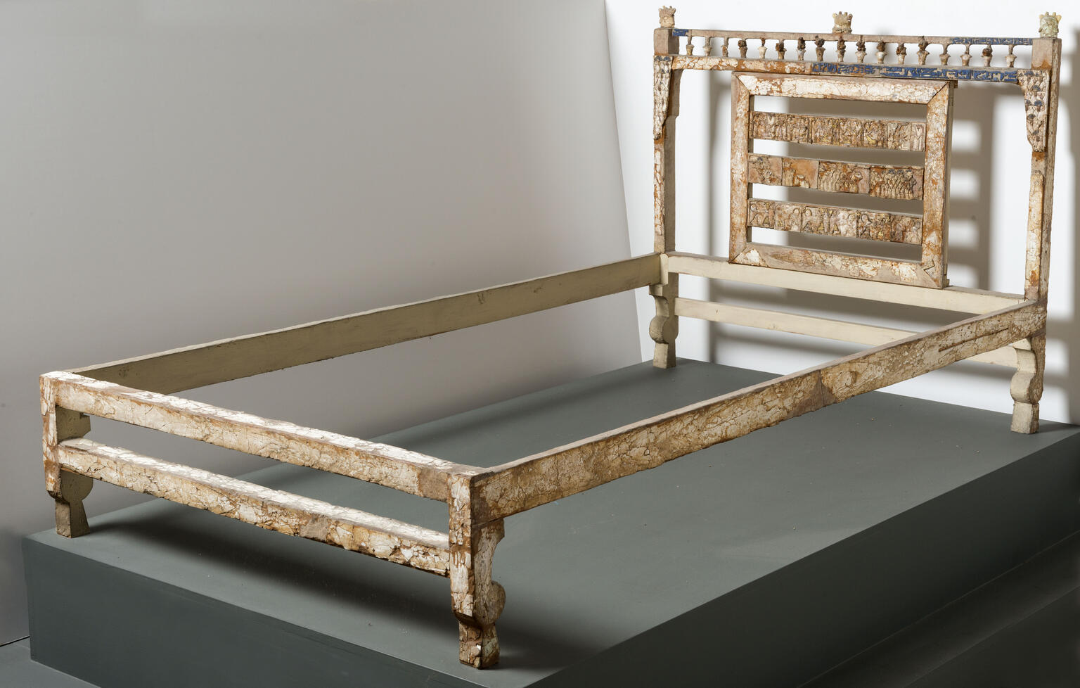 Bed frame decorated with ivory inlay with elaborate carving on headboard. Bed frame decorated with ivory inlay with elaborate carving on headboard.