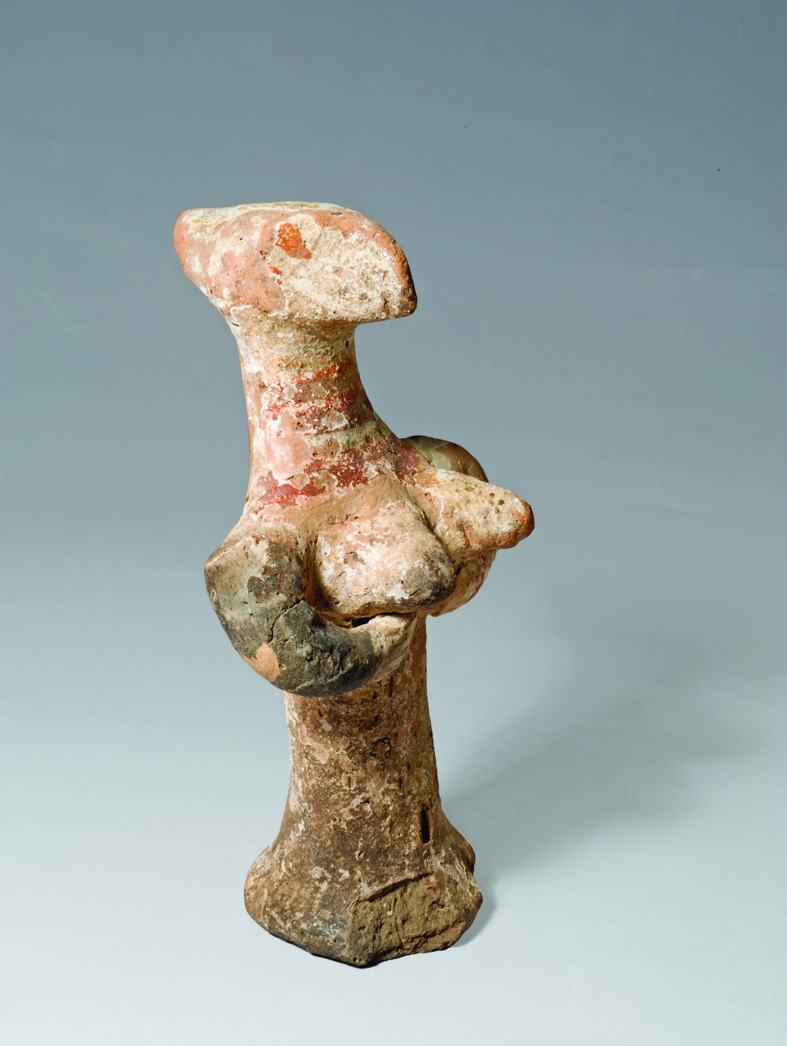 Terra-cotta figurine with enlarged head and breasts.